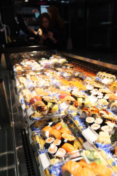 istock Assorted fresh sushi rolls display at grocery store 2166939652