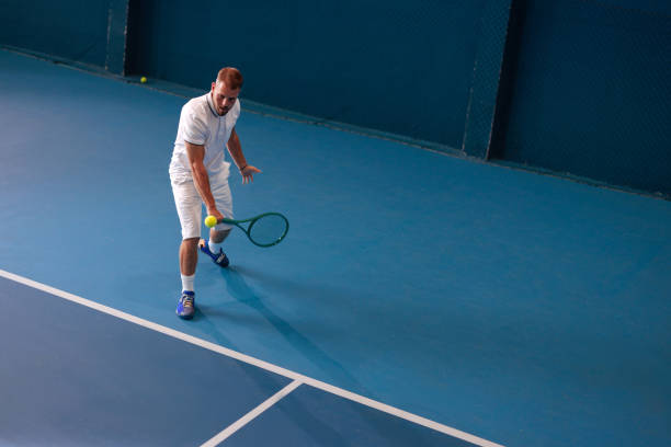 istock Male tennis player hitting a backhand slice shot 2166942439