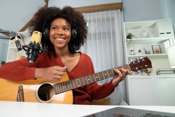 istock American African broadcasting on laptop with playing guitar. Tastemaker. 2166943923