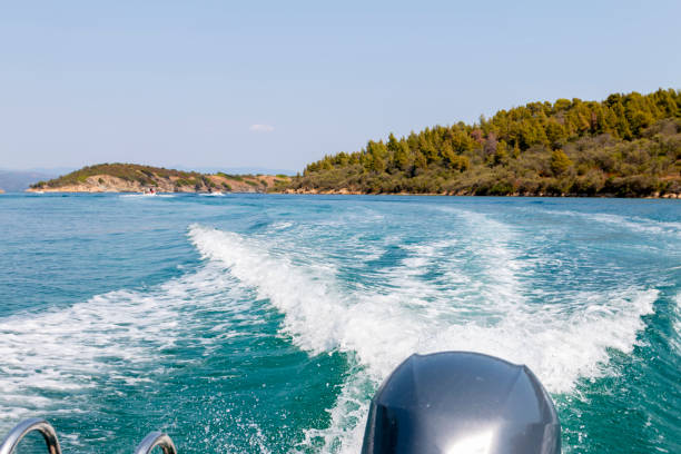 istock Boat motor on the sea and waves behind it. 2166944826