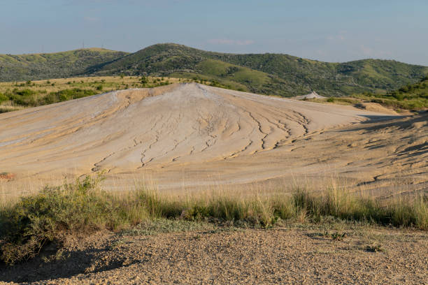 Arid landscape near Berca, Buzau, Romania, showcasing a rare European geological phenomenon. Here, gases from the earth emerge through the hills, creating small mud volcanoes and shaping a distinctive and remarkable landscape.