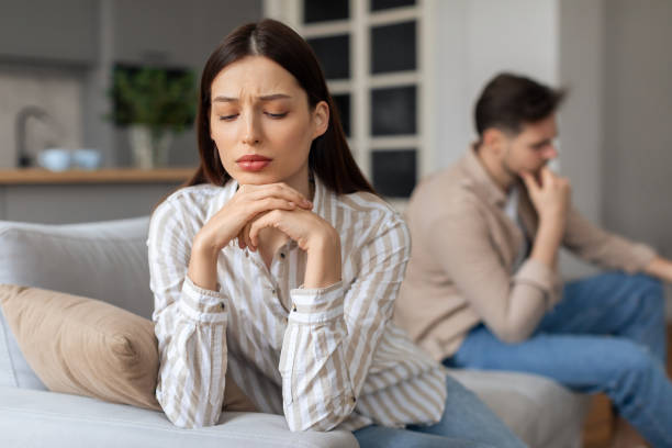 istock Concerned young woman with upset man in background 2166947636
