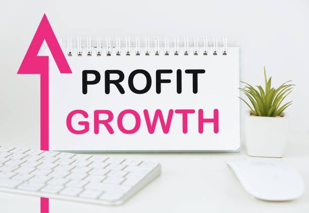 istock profit growth text on a notepad and an arrow pointing to the top 2166948444