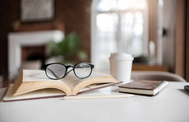 istock eyeglasses on book with coffee cup 2166954646