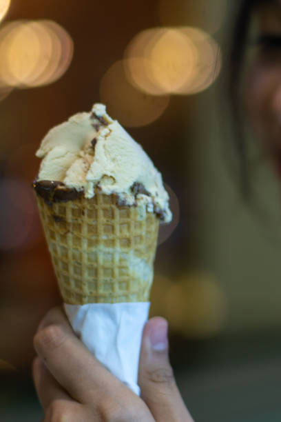 istock Person holding cone of ice cream 2166956745