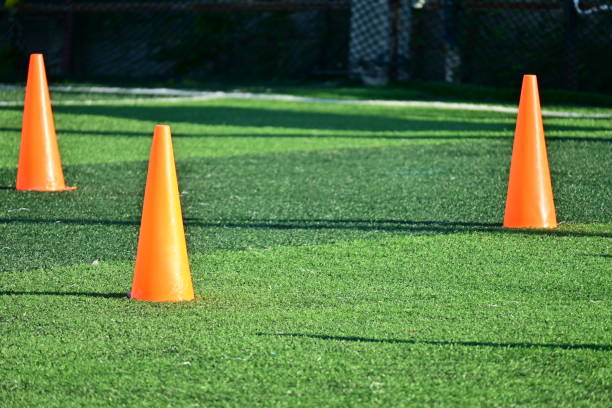 istock artificial green grass soccer field with orange training cones 2166956764