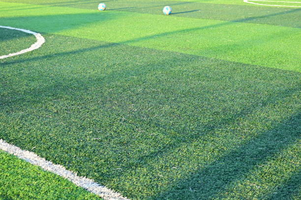 istock artificial green grass soccer field with white line 2166956924