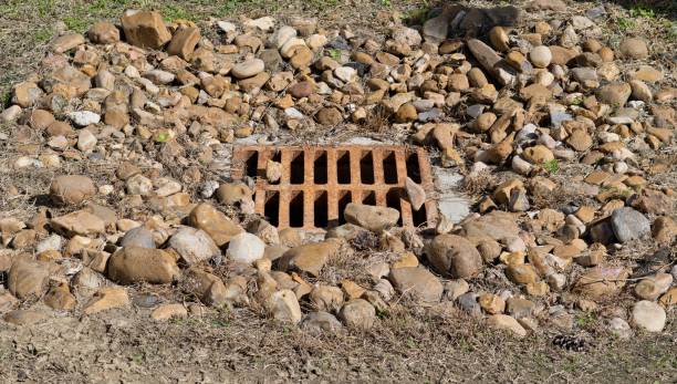istock Flood drain grate with drainage stones. 2166958597
