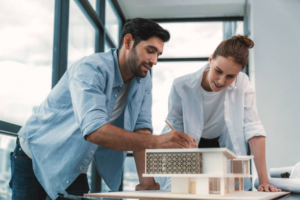 istock Smart architect engineer team working together to measure house model. Tracery. 2166961057