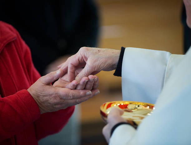 istock Catholic priest performing the sacrement of the Eucharist 2166961350