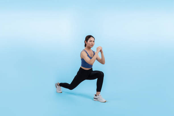 istock Vigorous energetic woman doing exercise with squat on isolated background. 2166961523