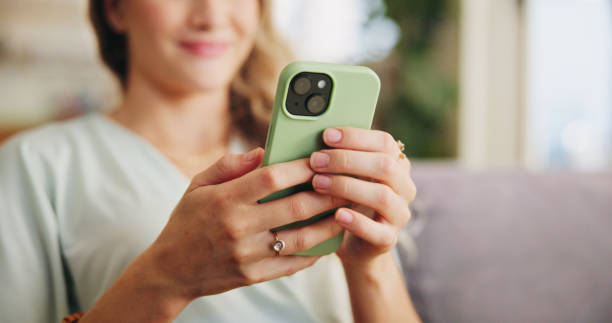 istock Home, sofa and woman with smartphone for scroll, chat and  text message for plans with online contact. Smile, female person and cellphone with dating website for flirting, match partner or mobile app 2166963004