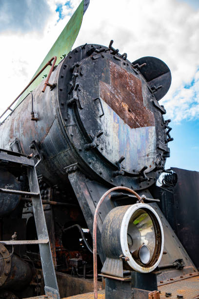 istock Details of an old rusty steam train in a railway yard under a cloudy sky 2166967237