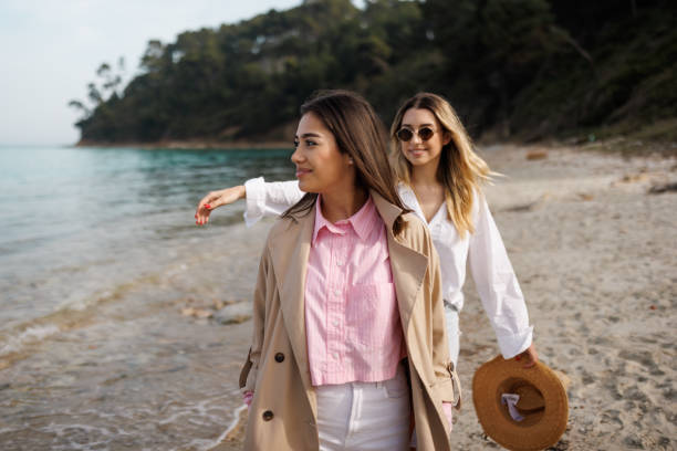 istock Cheerful friends walking by the sea 2166968716
