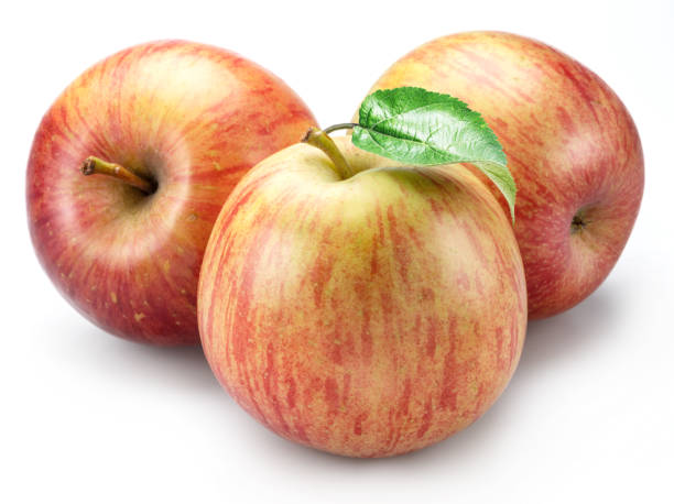 Striped delicious apples with apple leaf isolated on white background.