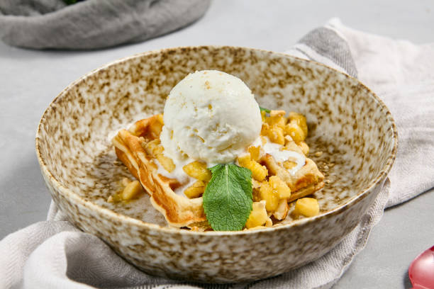 istock Delicious Viennese Waffle with Pear and Ice Cream in Rustic Ceramic Bowl 2166975171
