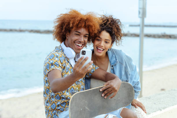 Young people taking selfie by the sea