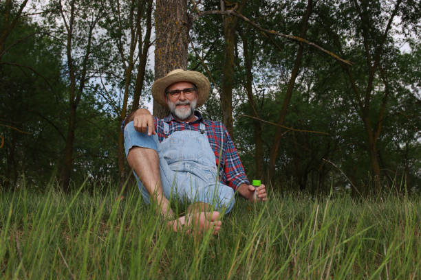 forest river nature green farmer bearded glasses modern jeans using technology drink refresh