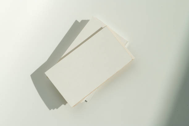 istock White blank business card on brown paper background with soft shadow. 2166981270