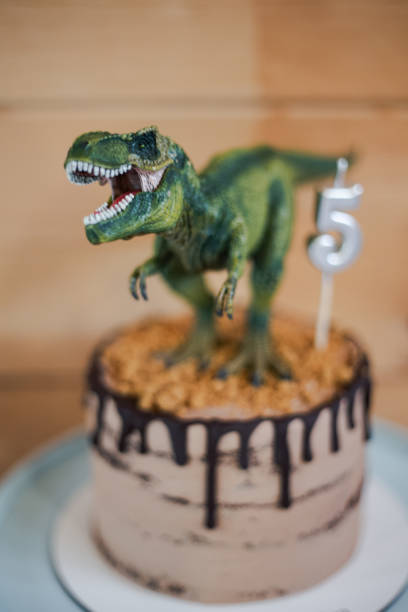 istock Rex dinosaur decoration on a chocolate cake birthday party 2166985568