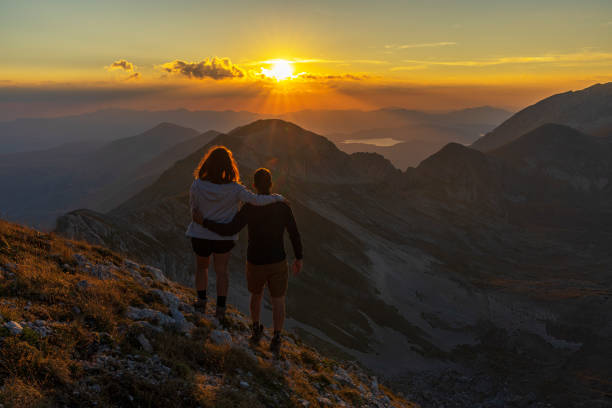 istock Couple watching sunset in the mountain, Italy 2166986399