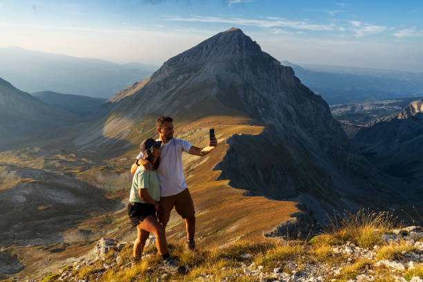 istock Couple taking selfie during the hike at sunset, Italy 2166986748