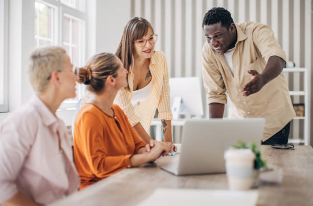 istock Team brainstorming and discussing ideas around laptop. 2166987778