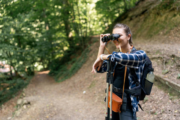 istock Hiker observing trail ahead with binoculars, curious. 2166988641