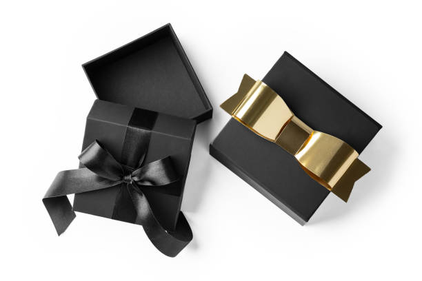 istock Opened black gift box and present with gold bow isolated on white background 2166988675