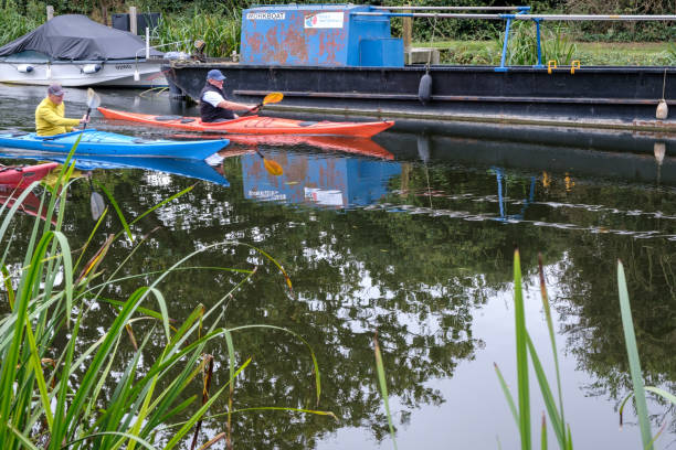 Worcester, Worcestershire, England, ~UK - 24 August 2025: People pushing wooden beams to open lock gates on the Worcester and Birmingham Canal.