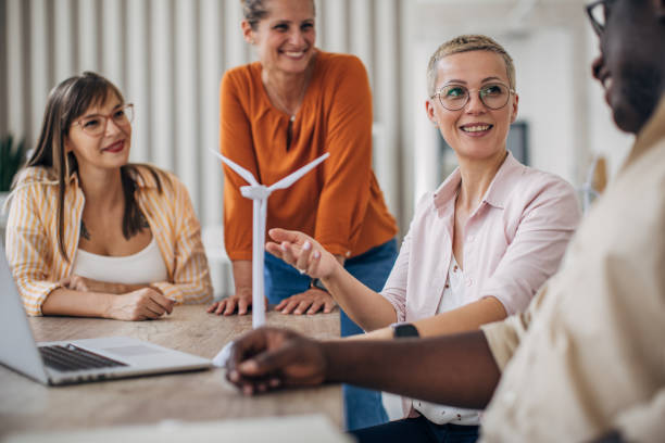 istock Team gathering around table discussing turbine model. 2166994786