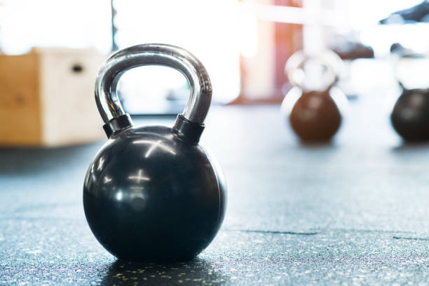 istock Kettlebells on floor in gym. Gym equipment for strength training. 2166995704