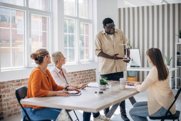 istock Team member presenting wind turbine model in meeting. 2166996557