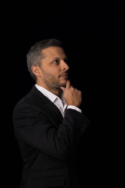 istock A man in a suit is looking down and thinking 2166999242