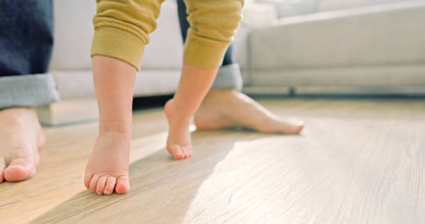 istock Father and baby boy walking barefoot 2166999314