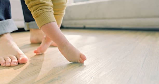 istock Father and baby boy walking barefoot 2166999316