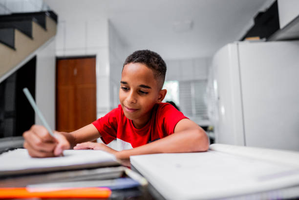 istock Child boy doing homework at home 2166999744