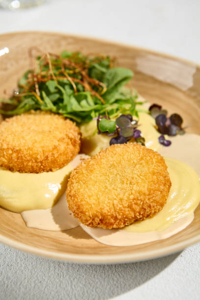 istock Mashed Potatoes with Fish Cutlets and Bisque Sauce Garnished with Mixed Greens 2167000092