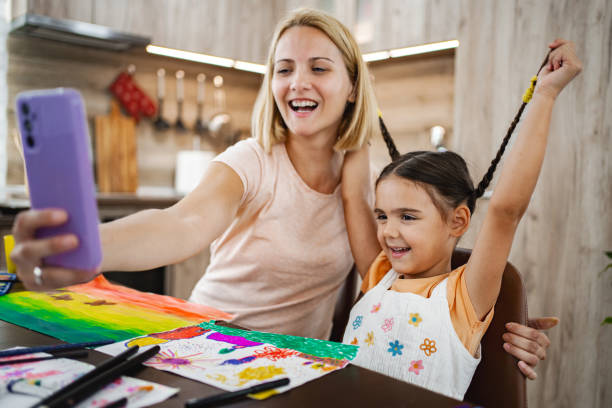 istock Mother and daughter enjoying a creative art session while taking a selfie at home during the afternoon 2167000997