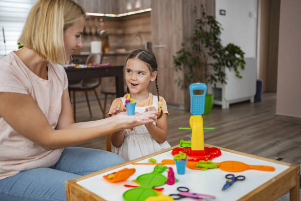 istock Mother and daughter enjoying creative playtime modeling plasticine 2167000999