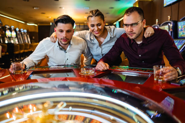 istock Three friends playing roulette in casino 2167004272