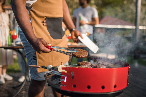istock A black man prepares a barbecue for his friends 2167004488