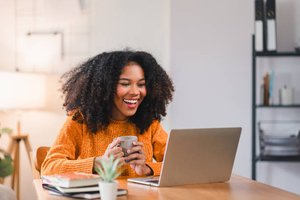 istock Smiling African American woman using a laptop while working from home. 2167005988