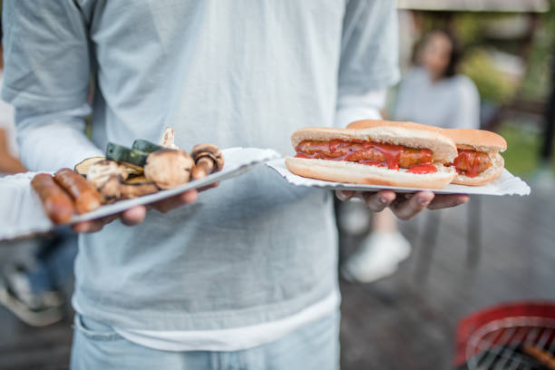 istock Unrecognizable man holding paper plates with barbecue 2167006069