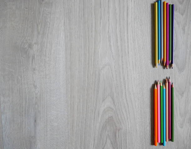 istock Colored pencils on wooden background for creative activities 2167007252