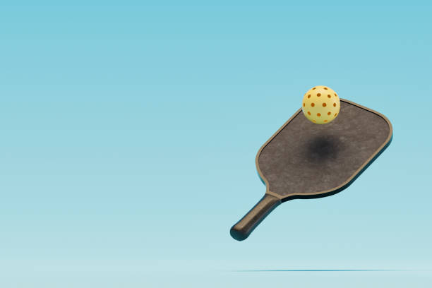 istock Pickleball racket and ball on blue background 2167007954