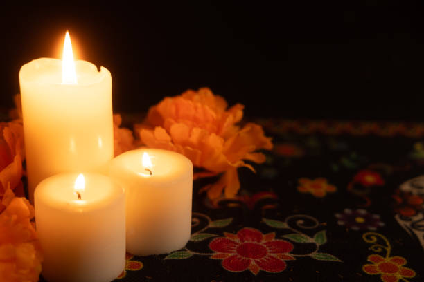istock Three flickering candles to the left, with bright orange marigolds framing the scene 2167010805