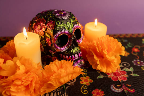 istock A skull embellished with metallic flowers, set between two lit candles 2167011410