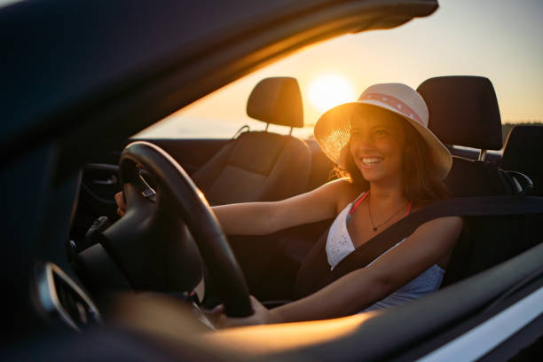 istock Happy girl driving a car during summer day 2167011432
