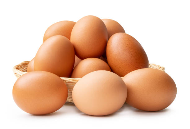 istock Fresh brown chicken eggs in stack in wicker basket isolated on white background with clipping path 2167012374